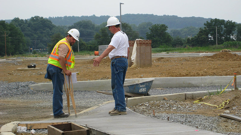 Two construction workers inspecting a project.